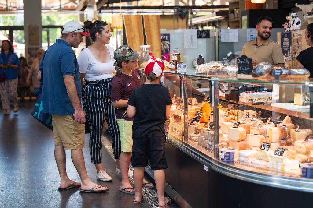 Famille devant l'étal du fromager